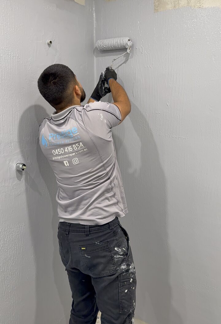 Prestige technician applying a waterproof membrane